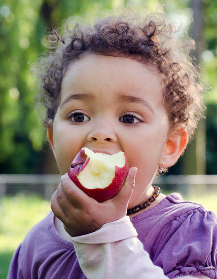Baby eating an apple