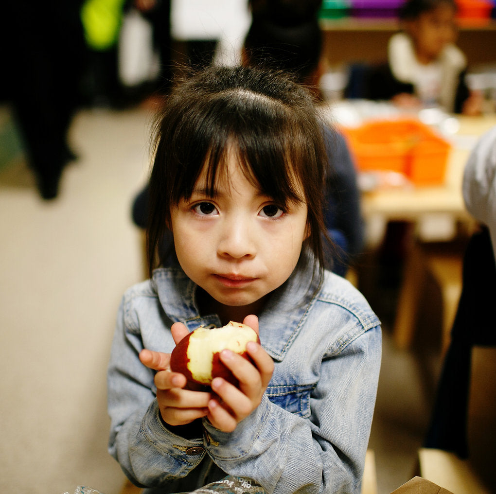 child eating an apple