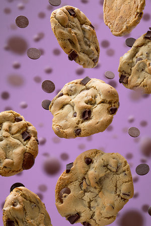 Photo of Triple Chocolate Chip cookies floating on purple backdrop